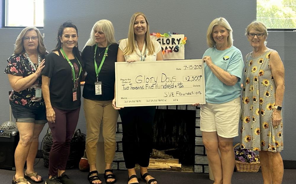 Check being presented to Glory Days Executives.