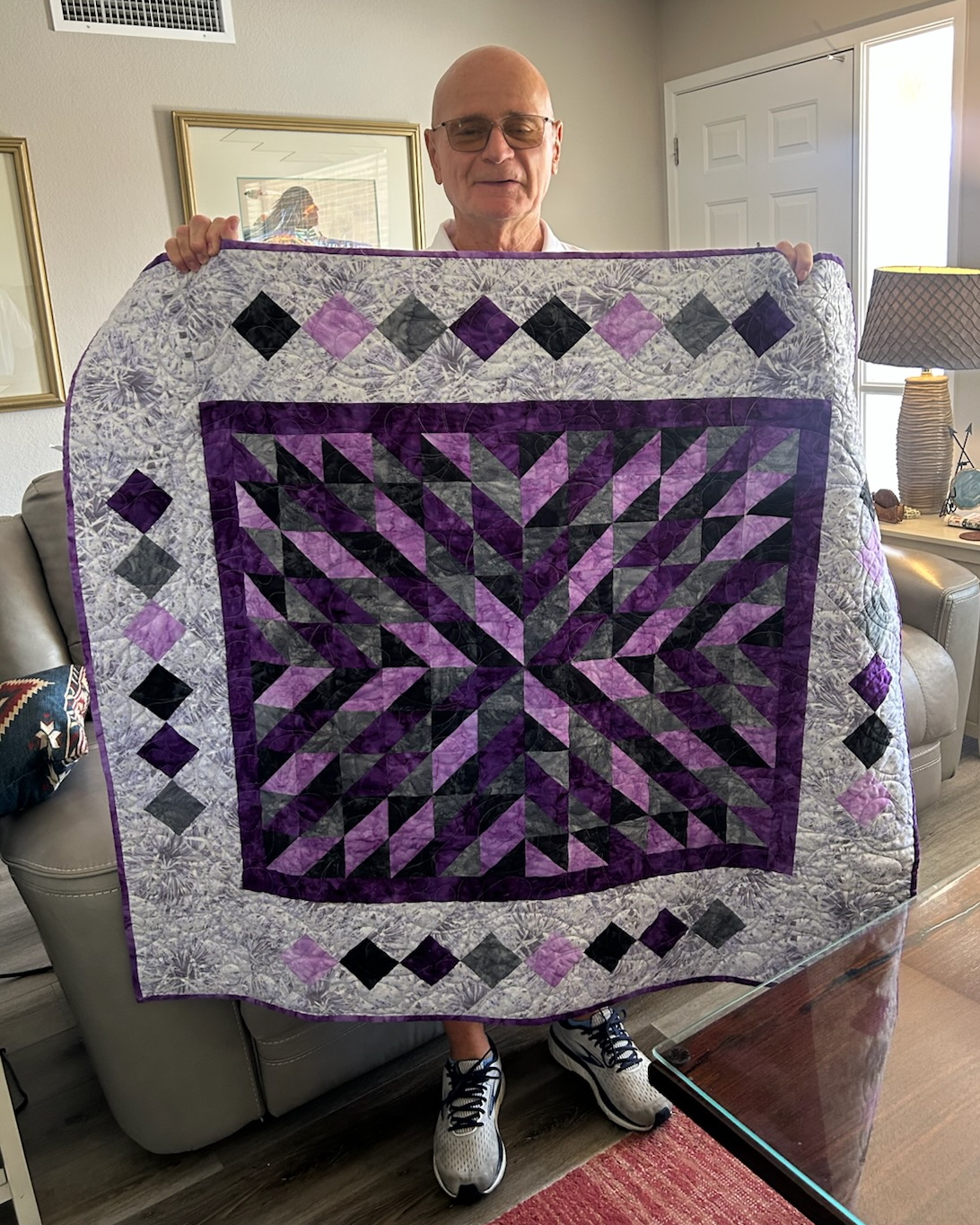 Bob Bernard holds up the quilt he won in the Foundation's raffle.